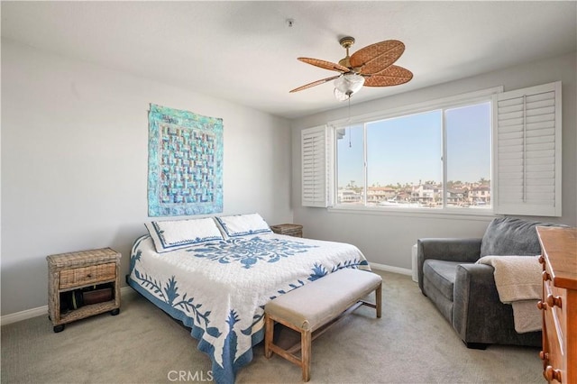 bedroom with light carpet and ceiling fan