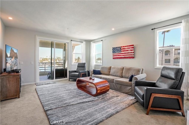 living room featuring light carpet and a wealth of natural light