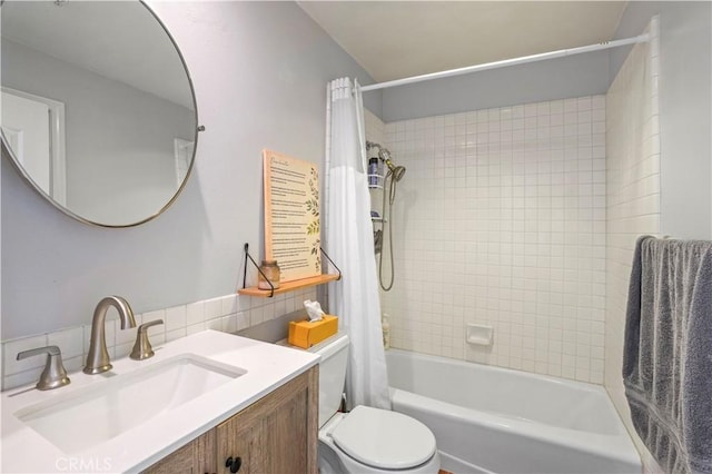 full bathroom featuring vanity, backsplash, shower / tub combo with curtain, and toilet