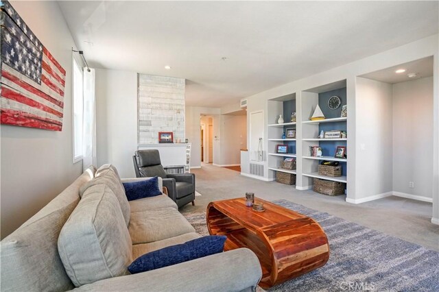 living room featuring built in features and carpet