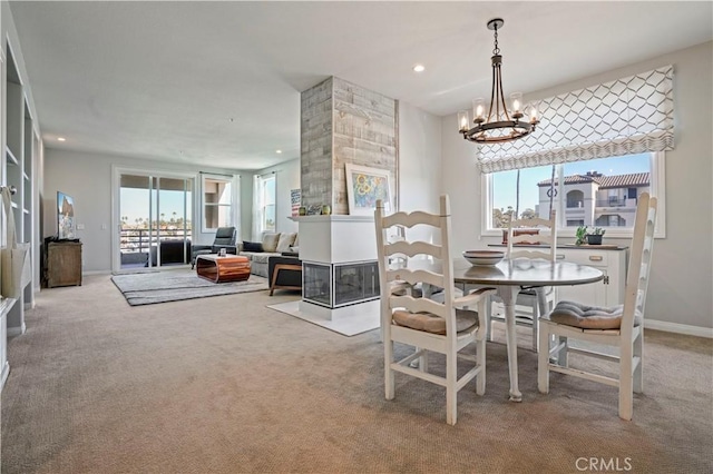 dining area featuring an inviting chandelier, light carpet, and a healthy amount of sunlight