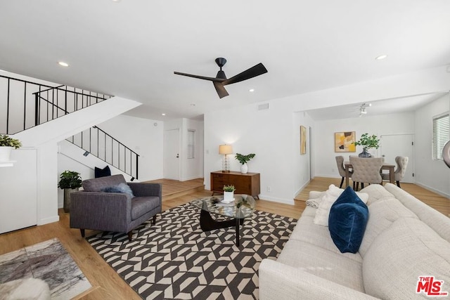 living room with ceiling fan and light hardwood / wood-style floors