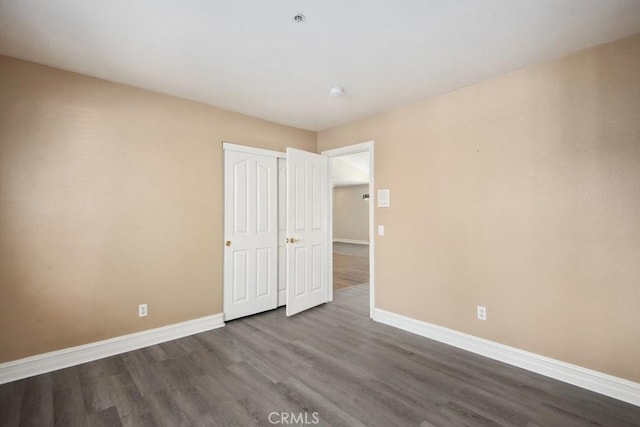 unfurnished bedroom featuring hardwood / wood-style floors and a closet