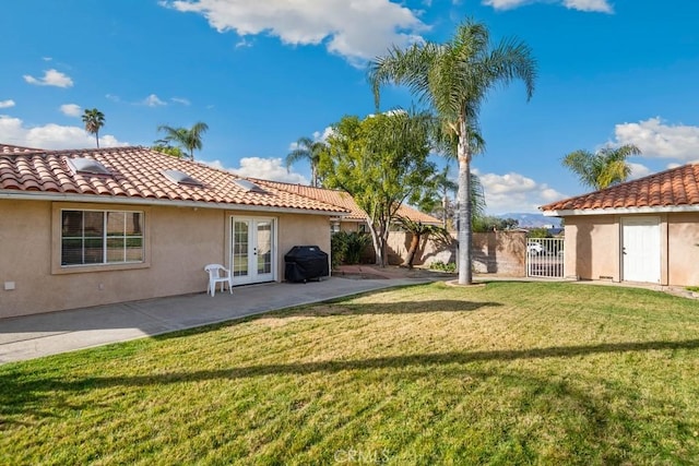 view of yard with french doors and a patio area