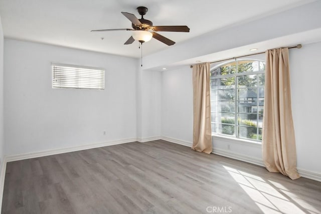 unfurnished room featuring ceiling fan, a healthy amount of sunlight, and light hardwood / wood-style floors