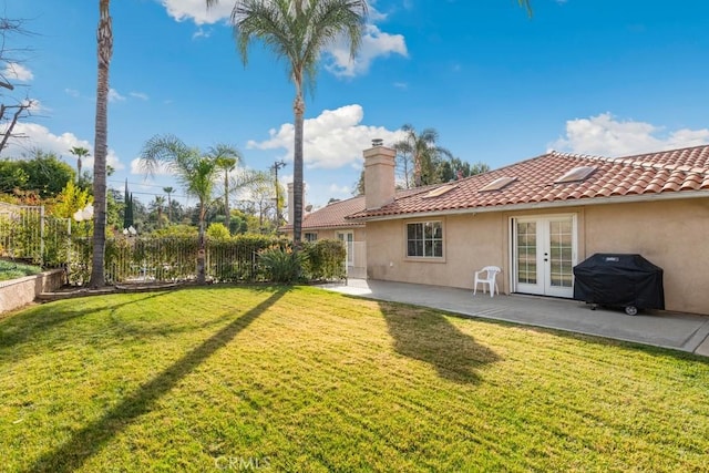 view of yard featuring a patio area and french doors