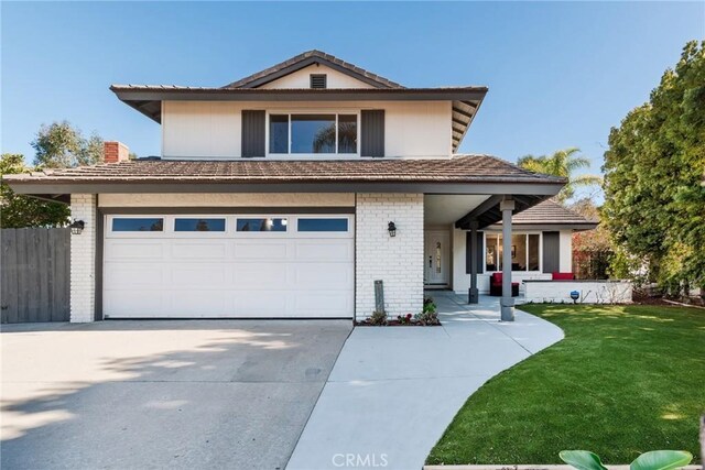 front facade with a front yard and a garage