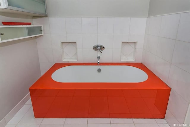 bathroom with a bathing tub and tile patterned flooring