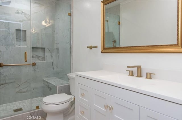 bathroom featuring toilet, walk in shower, and vanity