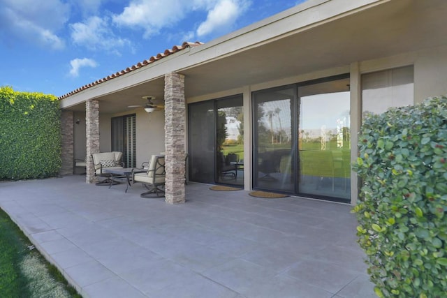 view of patio featuring ceiling fan