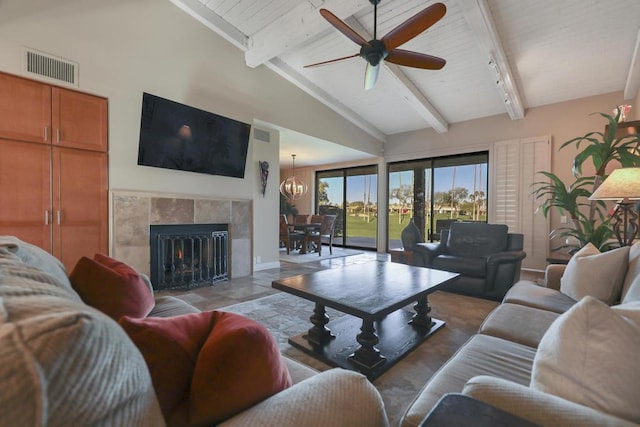 living room with wooden ceiling, ceiling fan with notable chandelier, a fireplace, and lofted ceiling with beams