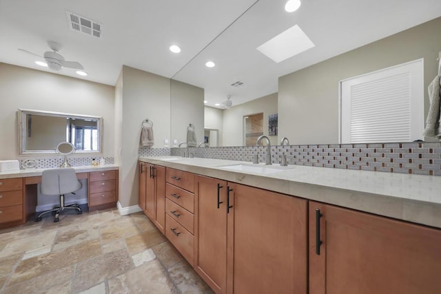 bathroom with vanity, ceiling fan, and tasteful backsplash