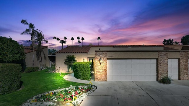 view of front facade featuring a garage and a lawn