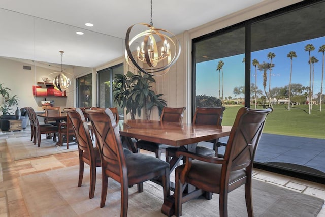 dining space with a wealth of natural light and a chandelier