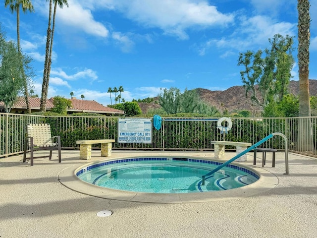 view of swimming pool with a mountain view