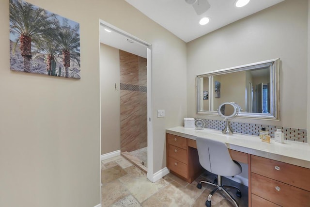 bathroom featuring vanity, ceiling fan, walk in shower, and tasteful backsplash