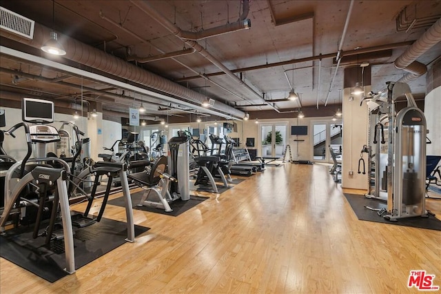 workout area with hardwood / wood-style floors