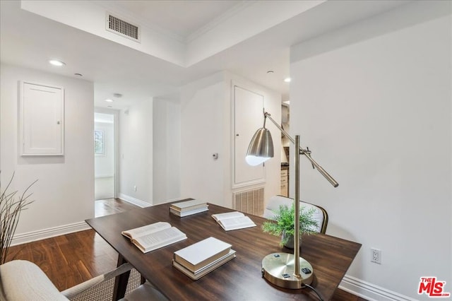 office space featuring wood-type flooring and ornamental molding