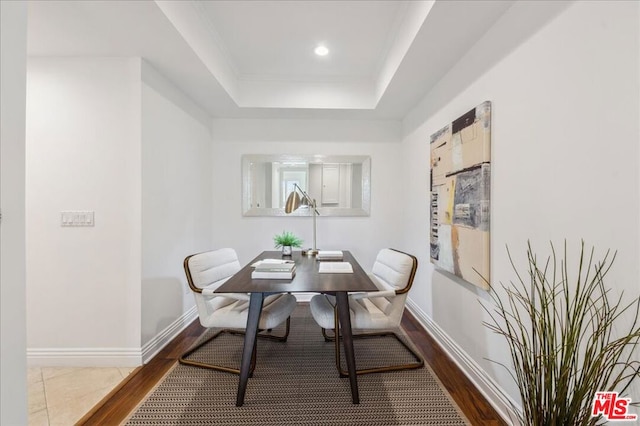 dining room with a raised ceiling and hardwood / wood-style floors