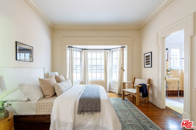 bedroom with dark hardwood / wood-style flooring, crown molding, and multiple windows