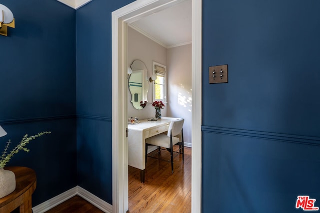 bathroom featuring hardwood / wood-style flooring and ornamental molding