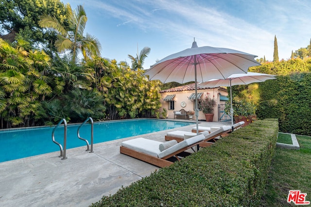 view of swimming pool featuring a patio area