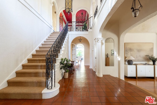 foyer featuring a towering ceiling