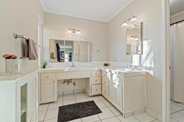 bathroom featuring crown molding, tile patterned flooring, and vanity