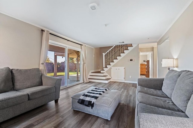 living room with dark wood-type flooring and ornamental molding