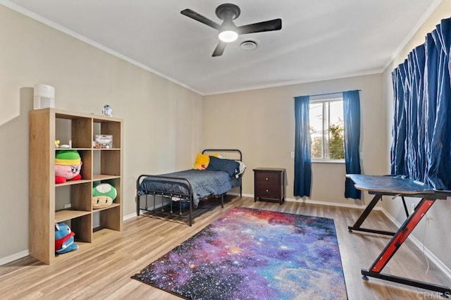 bedroom with hardwood / wood-style flooring, ceiling fan, and ornamental molding