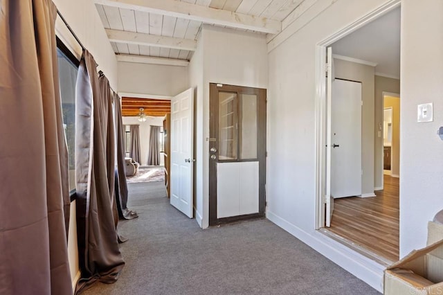 hallway with wood ceiling, carpet, and beam ceiling