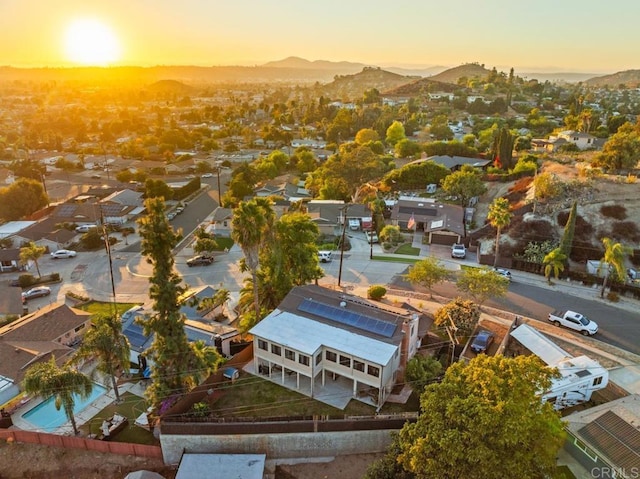 aerial view at dusk featuring a mountain view