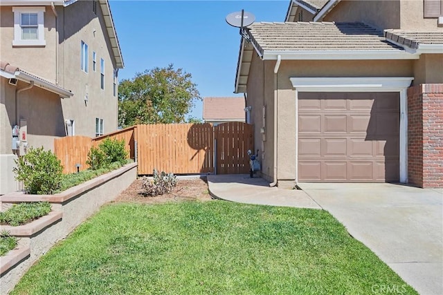 view of side of property with a garage and a lawn