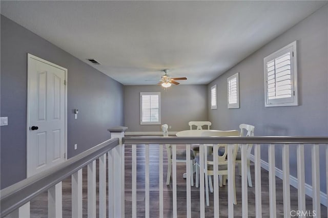 hallway with hardwood / wood-style flooring