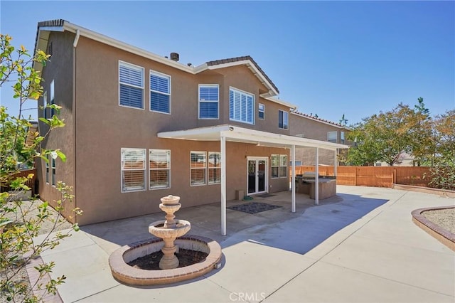 back of property featuring a patio