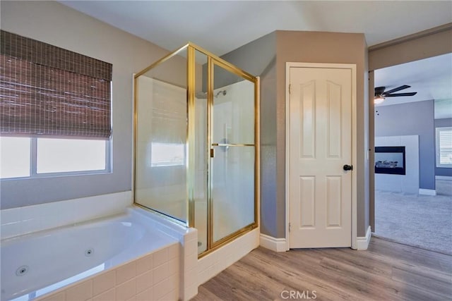 bathroom featuring hardwood / wood-style flooring, ceiling fan, and independent shower and bath