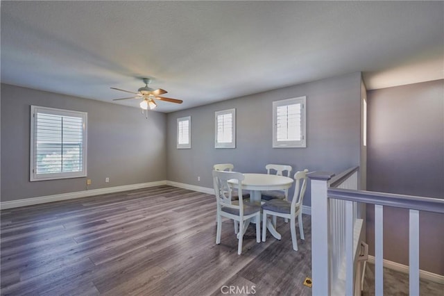 dining area featuring dark wood-type flooring and ceiling fan