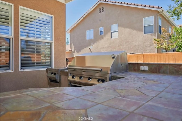 back of house featuring exterior kitchen and a patio