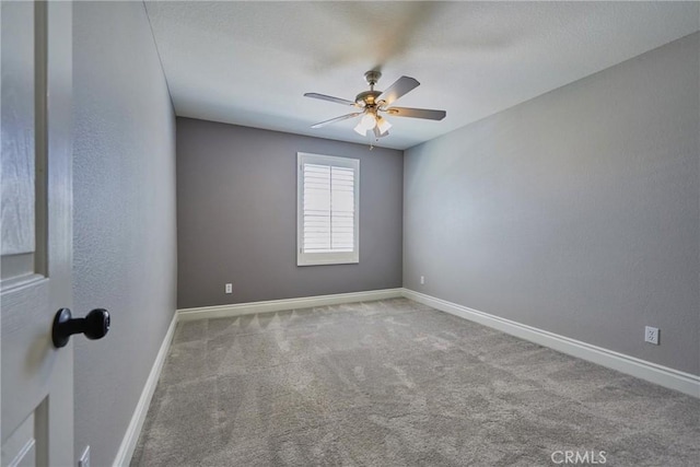 empty room featuring ceiling fan and carpet flooring