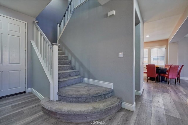 stairs featuring wood-type flooring