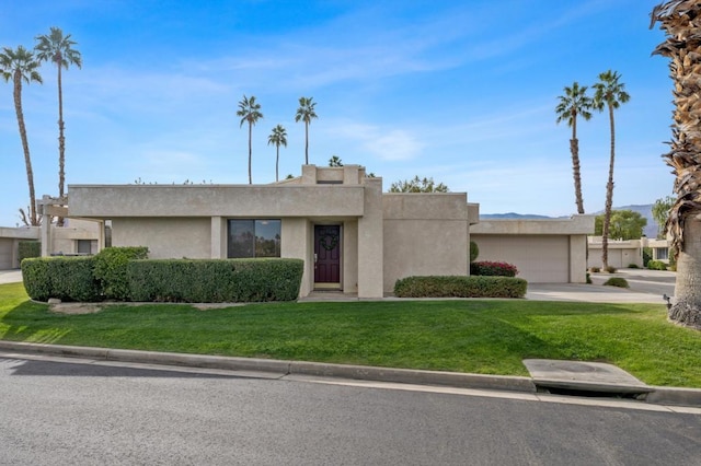 view of front facade with a front yard and a garage