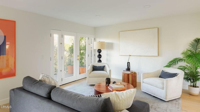 sitting room with light hardwood / wood-style flooring and french doors