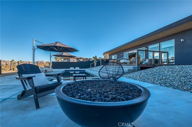 view of patio / terrace featuring a fire pit