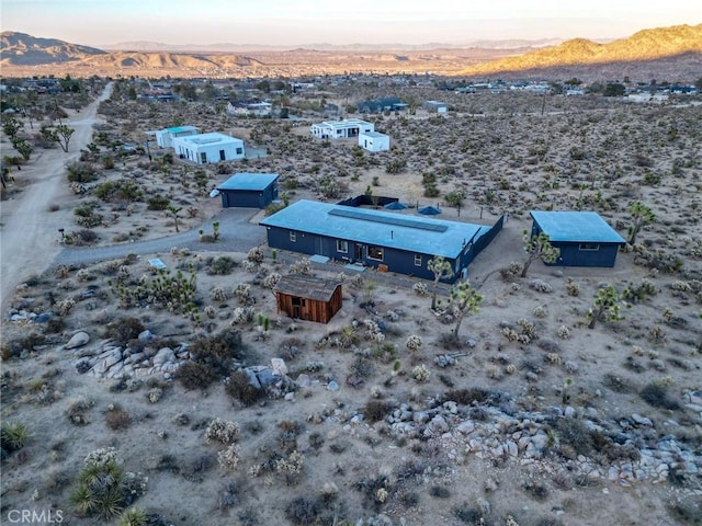 aerial view at dusk featuring a mountain view