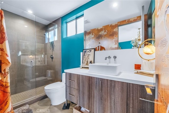 bathroom with toilet, a shower with shower door, and vanity