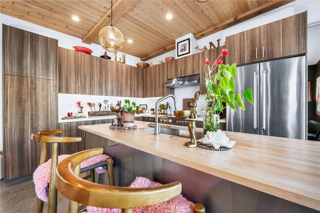 kitchen featuring wooden counters, decorative light fixtures, wooden ceiling, beam ceiling, and high end fridge