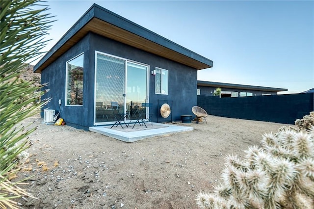 back of property with a patio