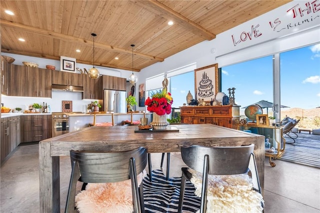 dining area featuring wooden ceiling, concrete flooring, and beam ceiling