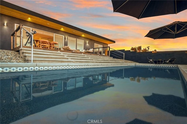 view of pool at dusk