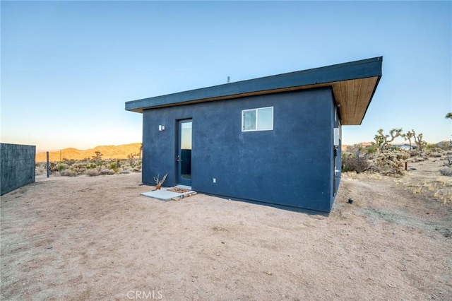 rear view of property featuring a mountain view